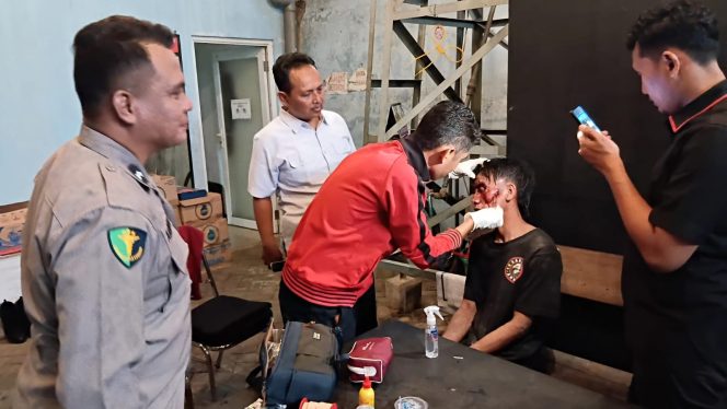 
					Petugas saat melakukan perawatan kepada seorang begal usai dihakimi massa di Wonorejo